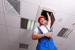 A Mechanic Holds One Hand With Ventilation While In Another Tool