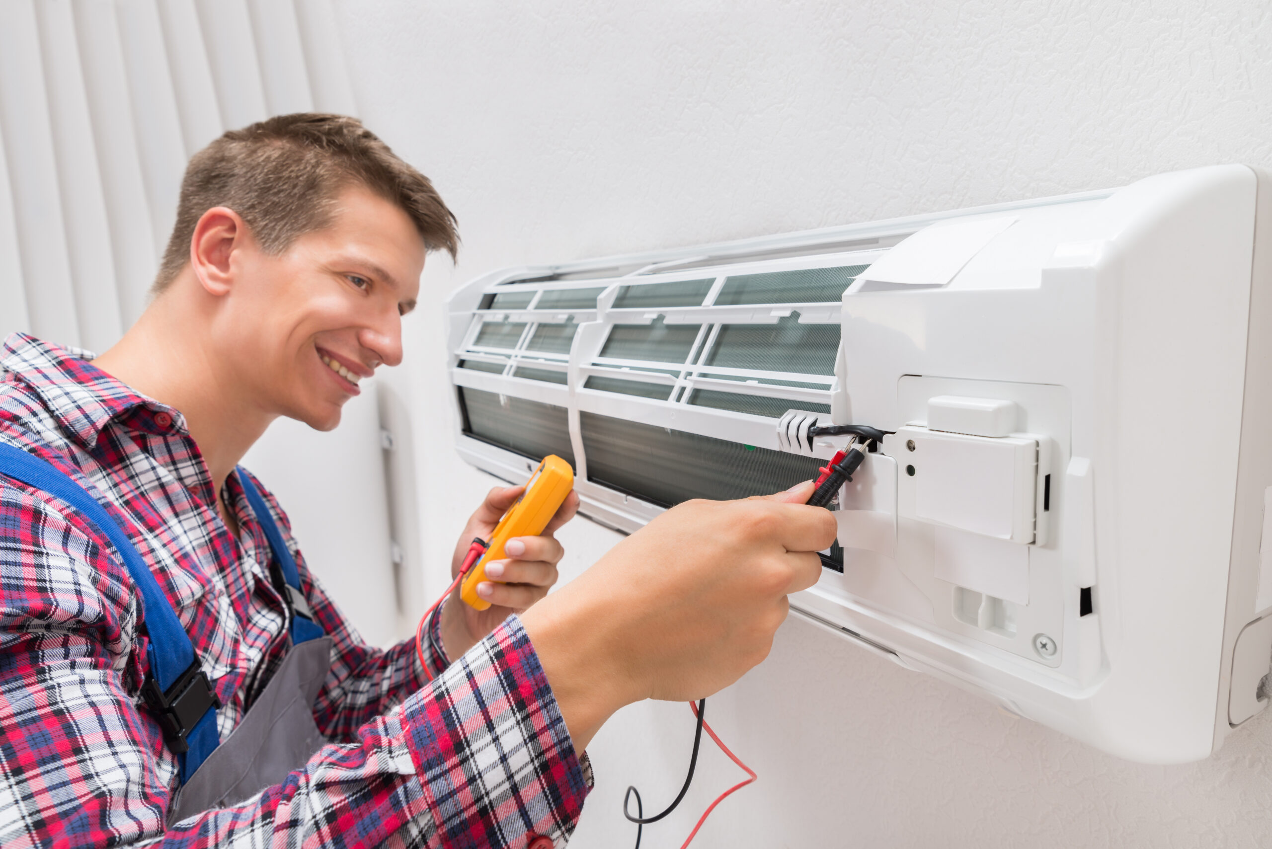 Technician Examining Air Conditioner Technician Examining Air Conditioner