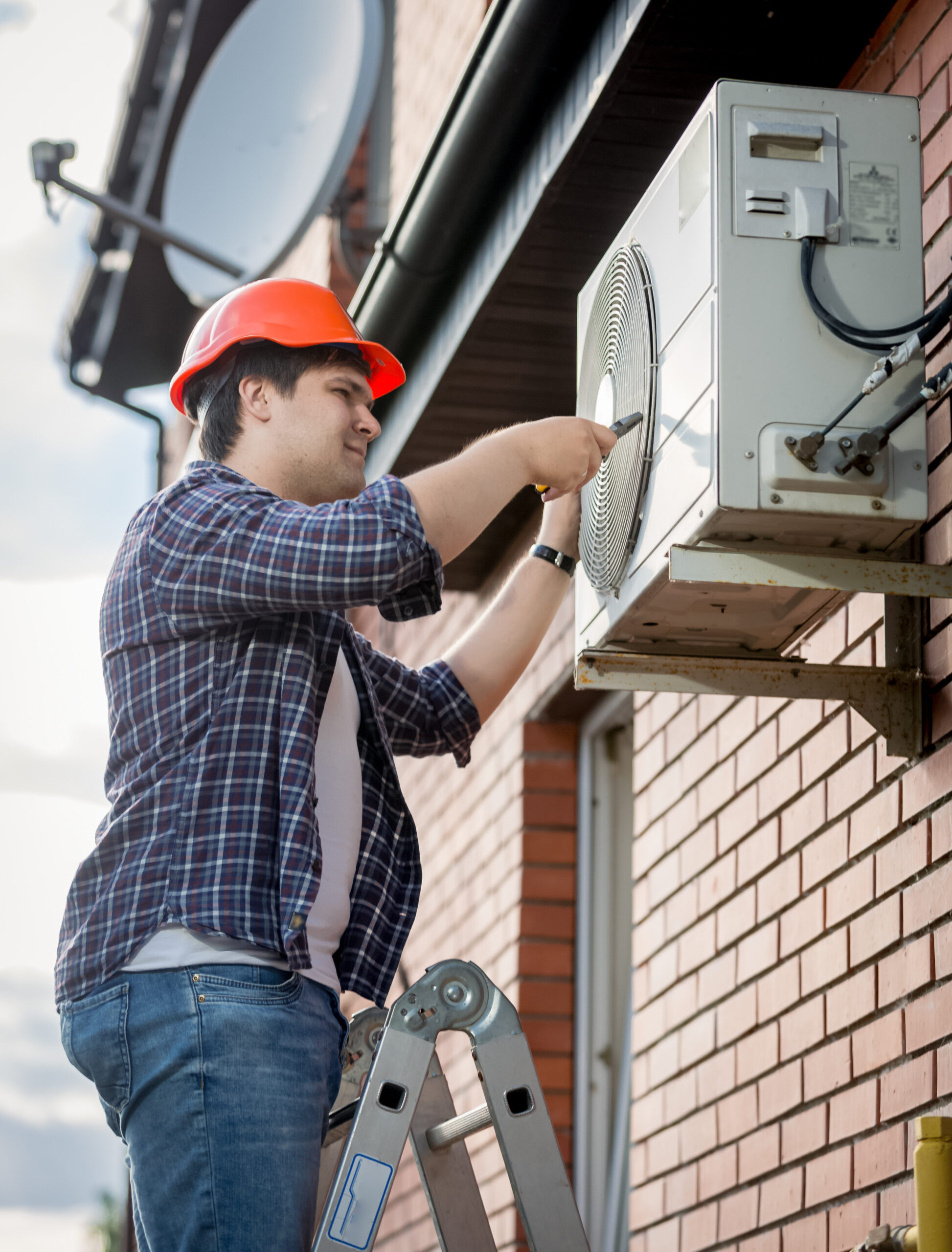 Male Technician Repairing Outdoor Air Conditioning System Male Technician Repairing Outdoor Air Conditioning System